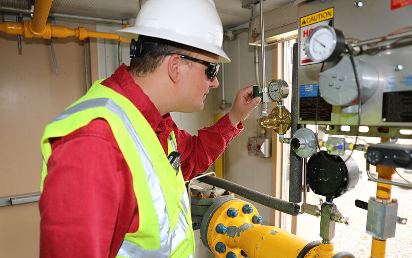 Douglas Pipeline engineering and operations employee working on guage