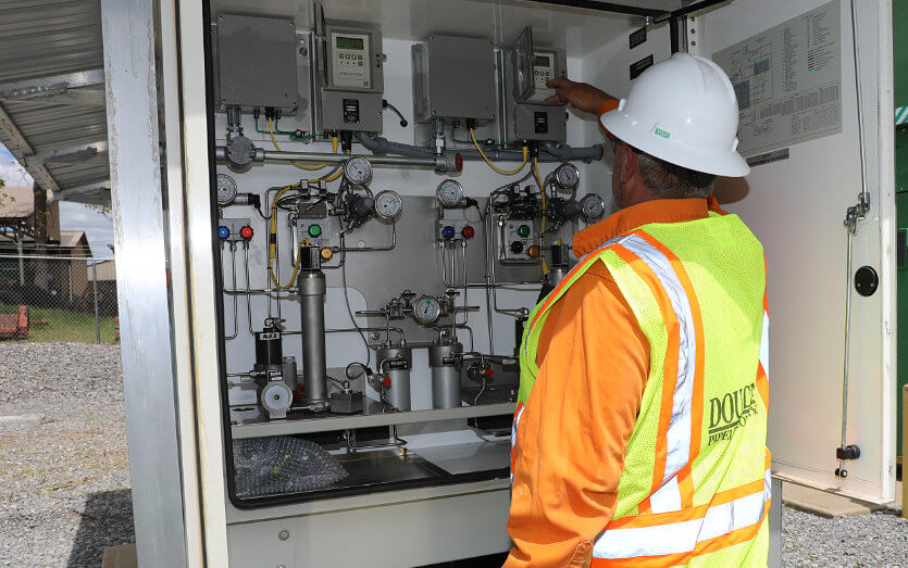 Pipeline engineering employee working on natural gas pipeline control box
