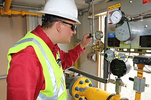 Douglas Pipeline employee checking out natural gas equipment